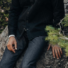 fit model sitting on a rock in The Slim Jean in Cone Mills Cordura Denim, Bottoms by Taylor Stitch