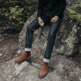 fit model sitting on a rock in The Slim Jean in Cone Mills Cordura Denim, Bottoms by Taylor Stitch