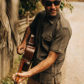 our fit model wearing The Caravan Shirt in Walnut Double Cloth—playing guitar, Wovens by Taylor Stitch