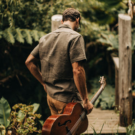 our fit model wearing The Caravan Shirt in Walnut Double Cloth—walking with guitar, Wovens by Taylor Stitch