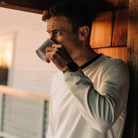 fit model wearing The Heavy Bag Long Sleeve in Natural, drinking coffee cropped, Knits by Taylor Stitch