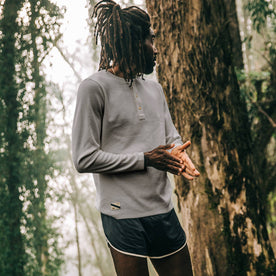 fit model wearing The Shoreline Henley in High Rise, looking right on trail, Knits by Taylor Stitch