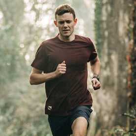 fit model wearing The Merino Tee in Wine, running in woods, Knits by Taylor Stitch