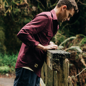 fit model wearing The Over Shirt in Wine, looking into water, Wovens by Taylor Stitch