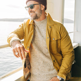 fit model wearing The Lombardi Jacket in Mustard Dry Wax, smiling on ferry, Outerwear by Taylor Stitch