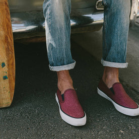 fit model wearing The Sano Slip-On in Rust Boss Duck, sitting on back of car, Footwear by Taylor Stitch