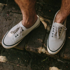 fit model wearing The Vista Sneaker in Natural Boss Duck, standing on stone stairway, Footwear by Taylor Stitch