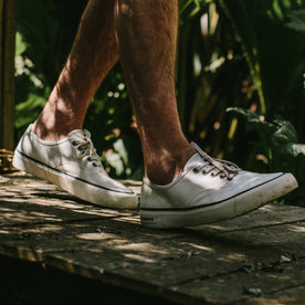 fit model wearing The Vista Sneaker in Natural Boss Duck, walking on pathway, Footwear by Taylor Stitch