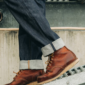 fit model wearing The Democratic Jean in Cone Mills Reserve Selvage, cuffed over boots, Denim by Taylor Stitch